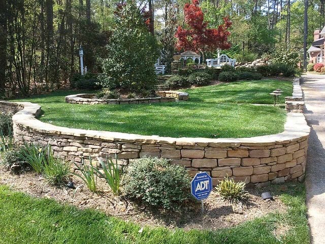 Curved stone retaining wall landscaping